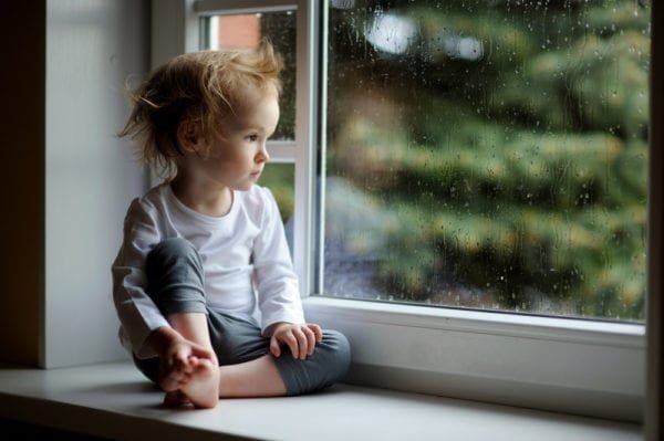 LITTLE KID LOOKING OUT WINDOW